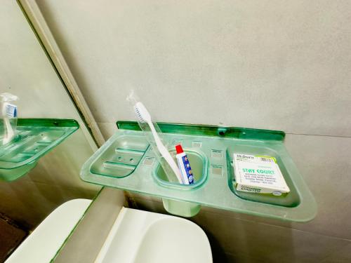 a bathroom with a tray with toothbrushes and toothpaste at Stay Court - Business Class Hotel - Near Central Railway Station in Chennai