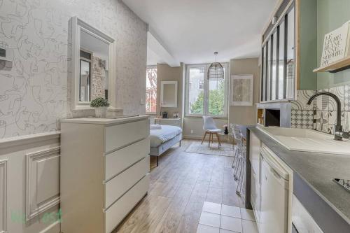 une cuisine avec un évier et un salon dans l'établissement Comfortable fully equipped studio - City Center, à Dijon