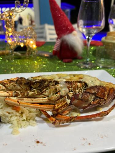 a crab sitting on top of rice on a plate at Gîte Ty Koko in Saint-François