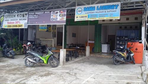 a group of motorcycles parked in front of a building at GreenKOST in Sintang