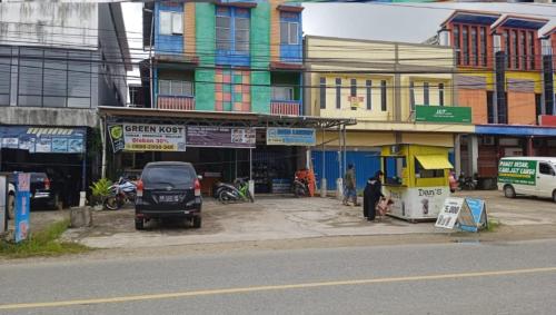 a group of buildings on a city street at GreenKOST in Sintang