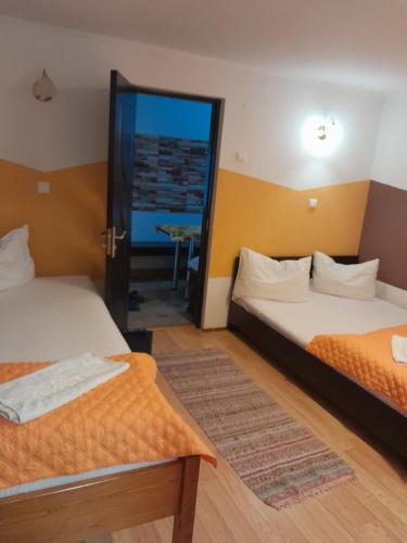a room with two beds and a mirror at Apartamente Ambrus E Studio 21 Praid in Praid
