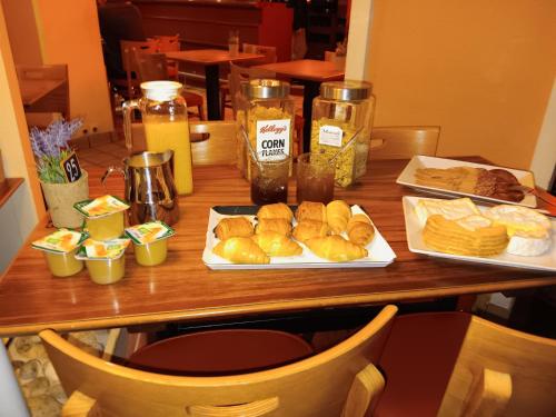 Hôtel Le Phare في اويسترهام: طاولة عليها طبقين من الخبز والمعجنات