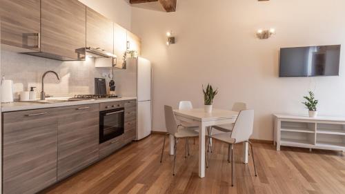 a kitchen with a table and chairs in a room at [Piazza Martiri]-In pieno centro sotto al Castello in Carpi