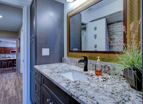 a bathroom with a sink and a mirror at Florida Life on the Water. Heated Pool, fishing, kayaks, gameroom in Palm Harbor