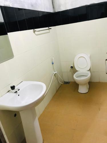 a bathroom with a sink and a toilet at Relation Hotel in Colombo