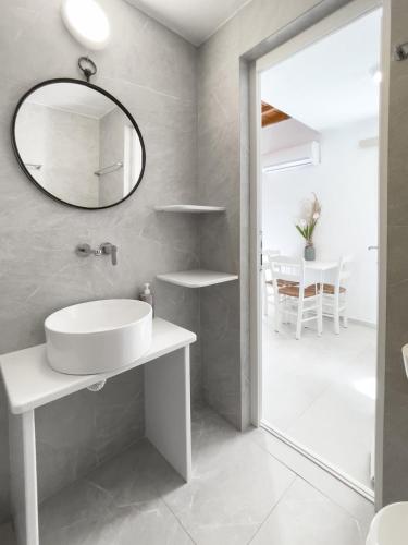 ein Badezimmer mit Waschbecken und Spiegel in der Unterkunft Twins Apartments By Mina in Ornos