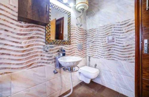 a bathroom with a sink and a toilet at Abbey Cottage in Dharamshala