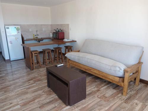 a living room with a couch and a table at Bahia Rooms in El Calafate