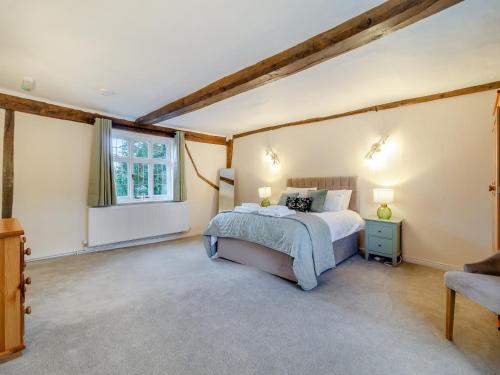 a bedroom with a large bed and a window at The Farmhouse - Uk45894 in Banham