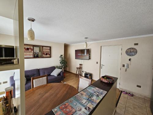 a living room with a table and a couch at Apartamento full equipado in Temuco