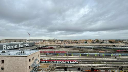 a large train yard with trains in a city at Cunabu Apartments in Rome