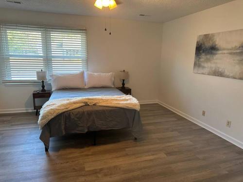 a bedroom with a bed and a painting on the wall at Just like home! in Huntsville