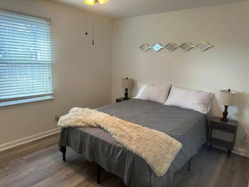 a bedroom with a bed and a window at Just like home! in Huntsville