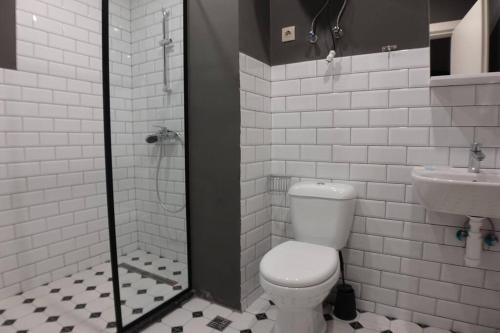 a white bathroom with a toilet and a sink at Roshka Apartment 108 in Gudauri