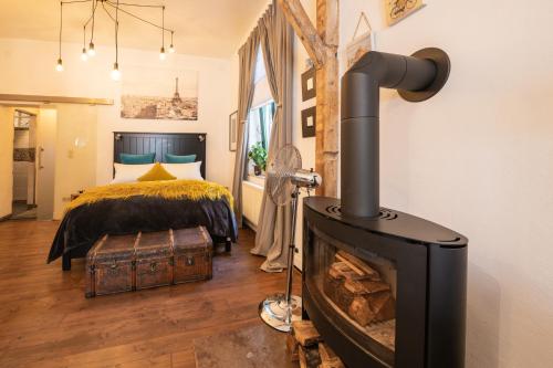 a bedroom with a fireplace in front of a bed at Boutique Apartments Benz I-III in Bergisch Gladbach