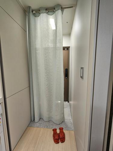 a pair of red shoes sitting in front of a shower at World-cup stadium, New house, full optioned in Goyang