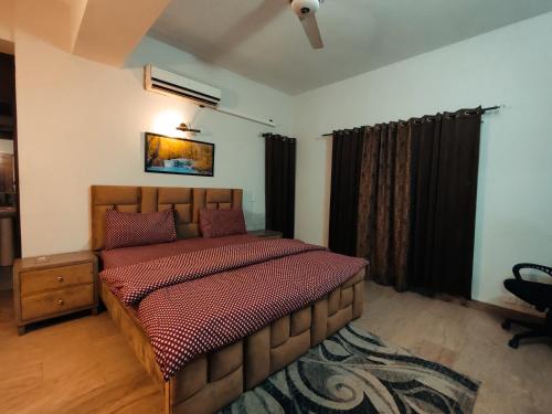 a bedroom with a large bed in a room at APARTMENTS of Comfort! in Islamabad