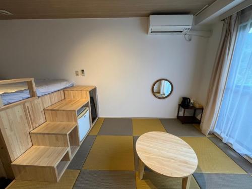 a small room with a table and a bed at CHENDA INTERNATIONAL HOTEL with 2 Small Double Beds - Vacation STAY 82751v in Seki