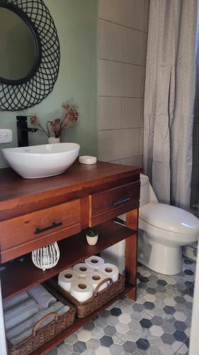 a bathroom with a sink and a toilet at Henko House in Quepos