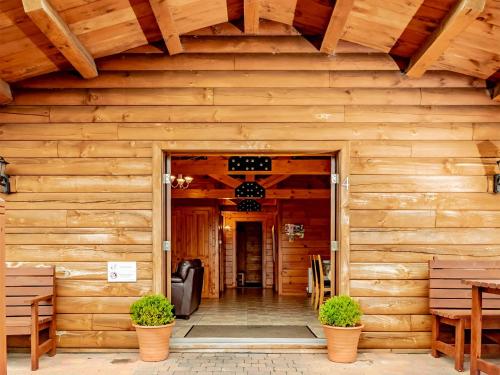 an entrance to a wooden building with benches at 4 Lakeview Lodge in Boston