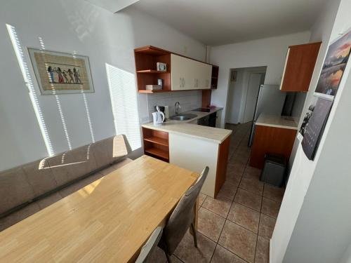 a small kitchen with a wooden table and a counter top at Marta in Klagenfurt