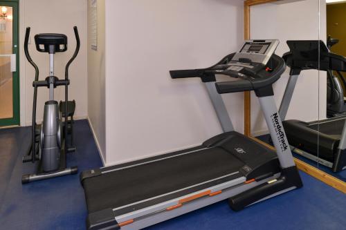 a gym with a treadmill and two exercise bikes at Canadas Best Value Inn Valemount in Valemount