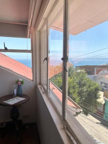 a room with a window with a table and a view at Hotel Boutique & Spa Puerto Natura in Valparaíso