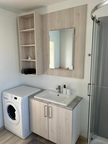 a bathroom with a washing machine and a sink at Holiday Homes Ahil 7&8 in Pakoštane