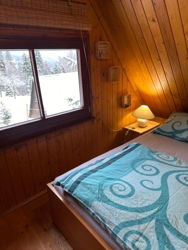 a bedroom with a bed and a window at Domek na Polance in Rajcza