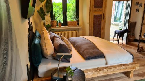 a bed with pillows on it in a room at Boutique Apartments Benz I-III in Bergisch Gladbach
