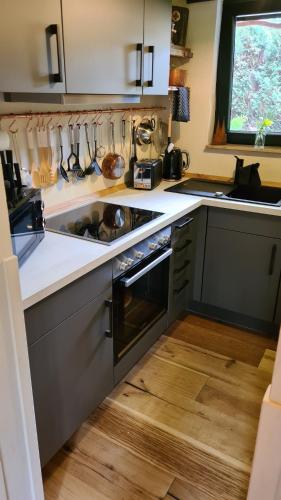 a kitchen with a sink and a stove at Boutique Apartments Benz I-III in Bergisch Gladbach