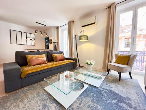 un soggiorno con divano e tavolo in vetro di Luxueux 3 pièces 80m2 - Espace bureau -1mn Beach Croisette a Cannes