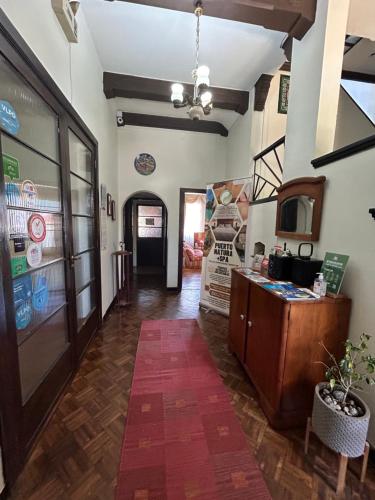 a hallway of a restaurant with a red rug on the floor at Hotel Boutique & Spa Puerto Natura in Valparaíso