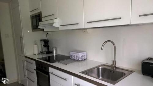 a kitchen with a sink and a counter top at City Apartment Snellmaninkatu 22 A in Kuopio
