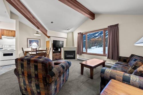 a living room with two couches and a kitchen at Cahilty #417 home in Sun Peaks