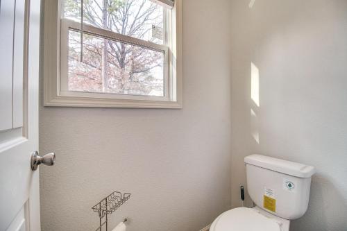 a bathroom with a toilet and a window at Grand Lake Views Pet-Friendly Jay Getaway! in Jay