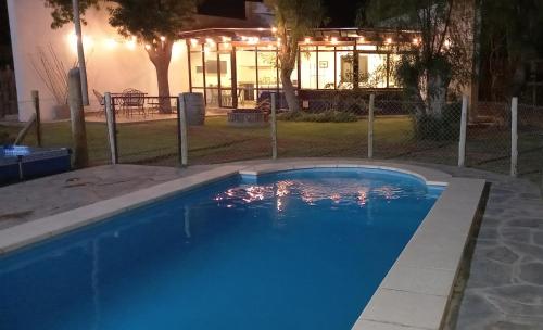 a swimming pool in front of a house at night at Departamento con piscina en Vistalba in Vistalba