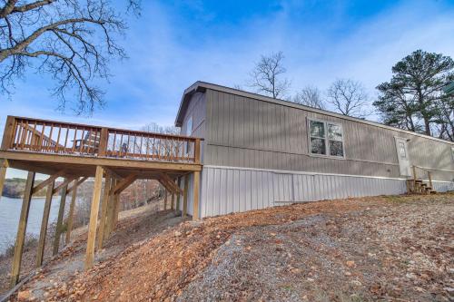a metal building with a deck next to a body of water at Grand Lake Views Pet-Friendly Jay Getaway! in Jay