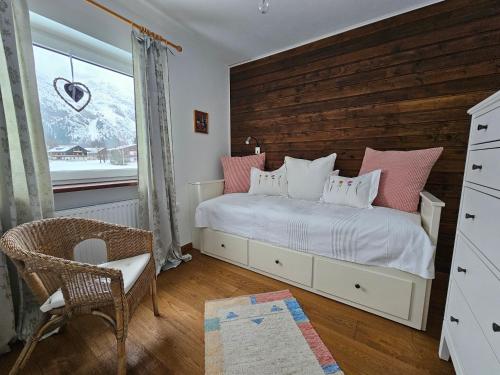 a bedroom with a bed with pink and white pillows at Landhaus Loipe in Leutasch