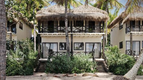 a house on the beach with palm trees at Casa Gitano in Tulum