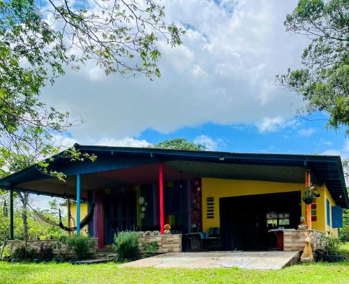 a house with a yellow at Chácara Lagoa do Palmital in Osório