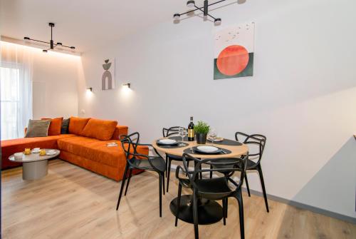 a living room with a couch and a table and chairs at MTP/ZOO Prestige Apartments in Poznań