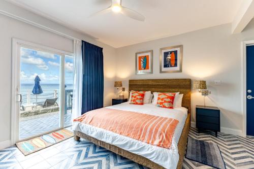 a bedroom with a bed and a large window at Sebastian's on the beach hotel in Road Town