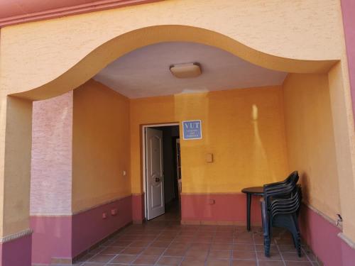 an archway in a hallway with a table and chairs at Chalet Islantilla "Costa de la Luz" in Lepe