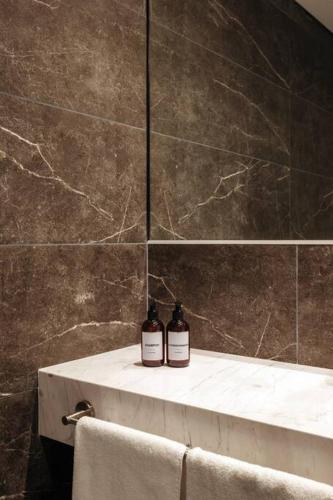 two bottles of soap sitting on a counter in a bathroom at ZENHAUS - Moderno apartamento Punta Carretas in Montevideo