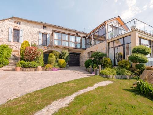 an exterior view of a large brick house at Appartement vue panoramique 2 personnes Horizon in Millau