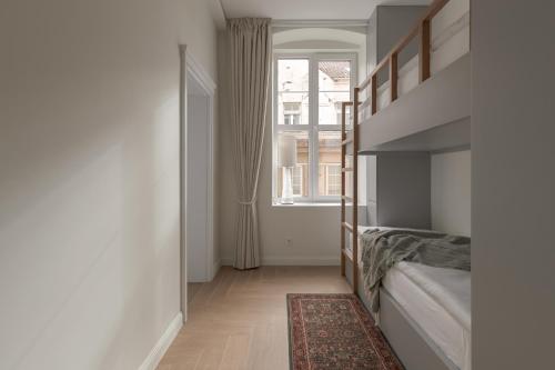 a bedroom with a bunk bed and a window at Comfort Stay - Old Town in Klaipėda