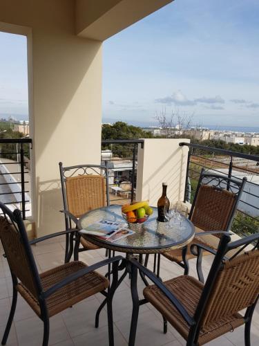 a table with a bowl of fruit on a balcony at Holiday Apartment with Sea View (0002913) in Paralimni