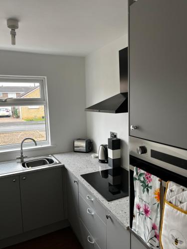 a kitchen with a sink and a stove top oven at Sunset Cottage in Stockton-on-Tees